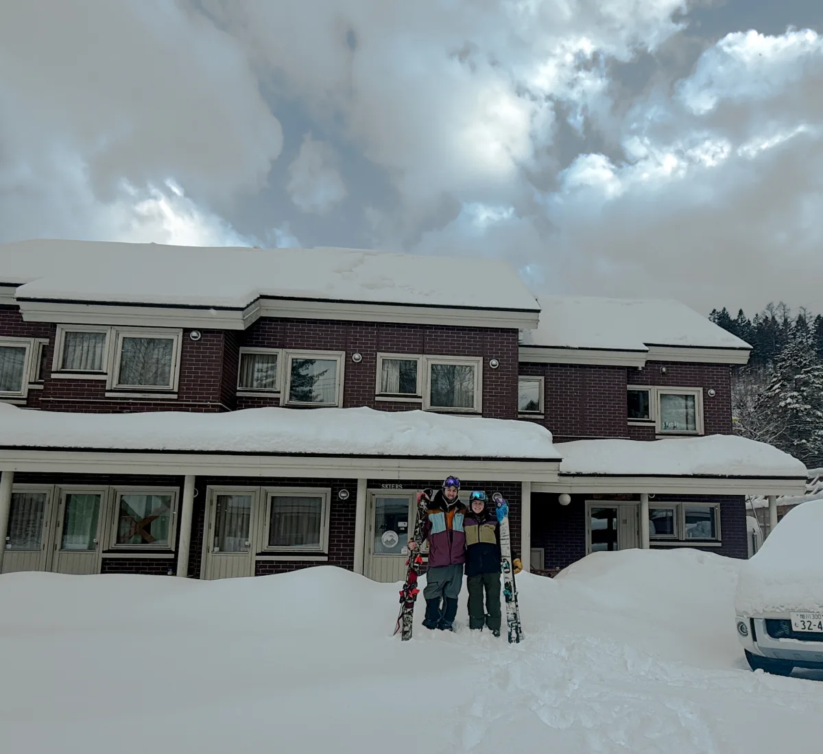 Denise and Riley outside Wakaranai Lodge in the snow